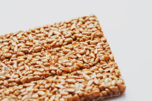 Healthy snacks. Fitness diet food. Kozinaki fritter, seeds, energy bars. White background top view. Isolate, Copy Space