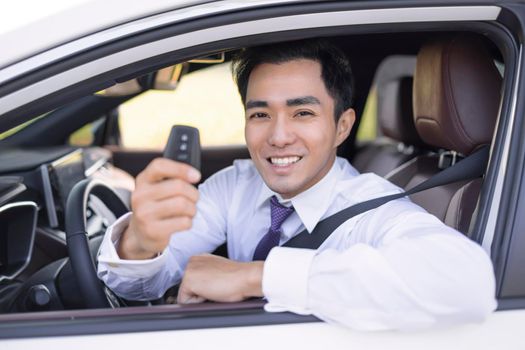 Business Man smiling and  showing car keys