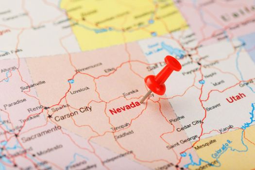 Red clerical needle on a map of USA, Nevada and the capital Carson City. Closeup Map Nevada with Red Tack