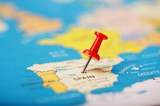 The location of the destination on the map of Spain is indicated by a red pushpin. Spain marked on the map with a red button