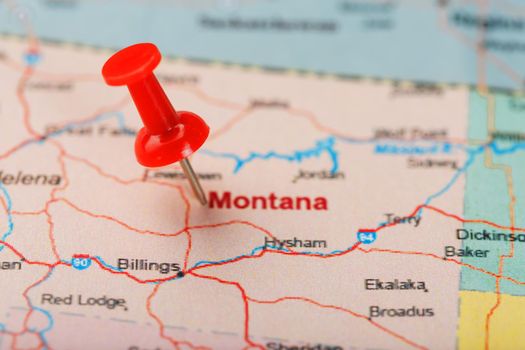 Red clerical needle on a map of USA, Montana and the capital of Helena. Close up Montana map with red tack