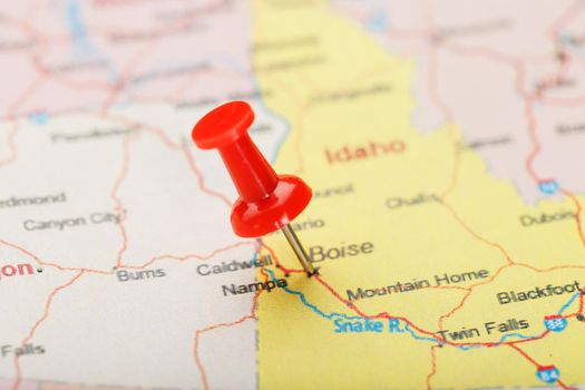Red clerical needle on a map of USA, Idaho and the capital Boise. Closeup Map Idaho with Red Tack