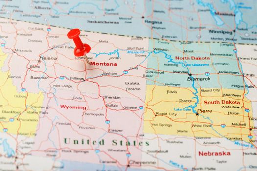 Red clerical needle on a map of USA, Montana and the capital of Helena. Close up Montana map with red tack