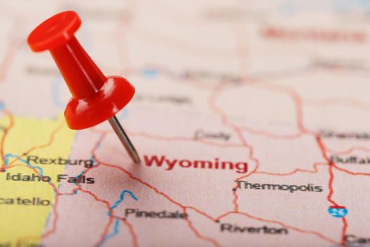 Red clerical needle on a map of USA, Wyoming and the capital Cheyenne. Close up map of wyoming with red tack