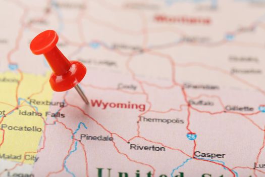 Red clerical needle on a map of USA, Wyoming and the capital Cheyenne. Close up map of wyoming with red tack