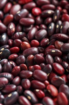 Closeup of a grain of red bean seeds. The texture of the legumes. Close up red beans background, seeds of red beans