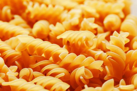 Background texture and pattern of boiled egg noodles in a spiral or pasta spaghetti screw. in full frame. View from above