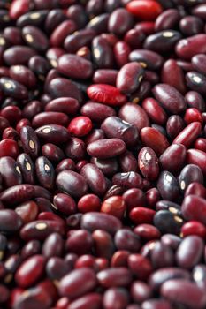 Closeup of a grain of red bean seeds. The texture of the legumes. Close up red beans background, seeds of red beans