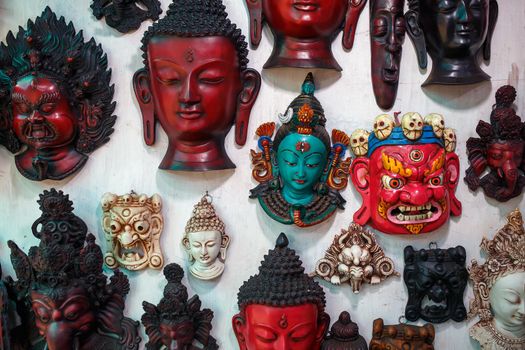 Colorful carved masks are sold, colored masks of different perfumes hang on the wall.