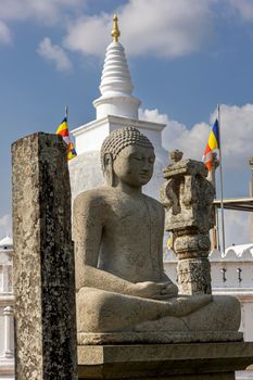 Sri Lanka. Anuradhapura. Thuparamaya Stupa is the earliest Dagoba to be constructed in the island. A statue of a sitting Buddha.