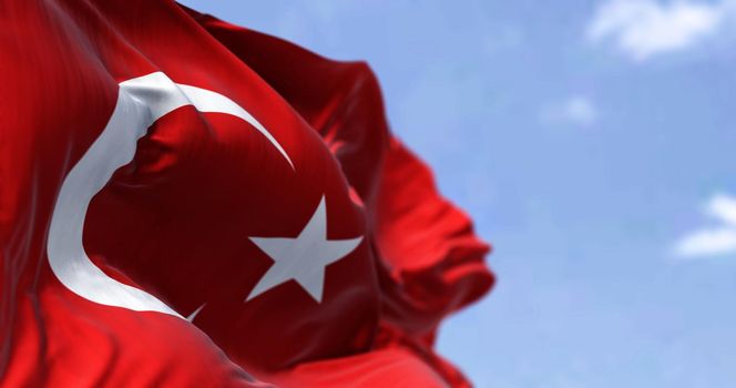 Detail of the national flag of Turkey waving in the wind on a clear day