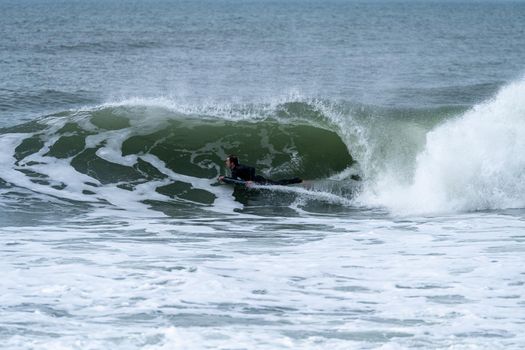 Bodyboarder performing a tube trick