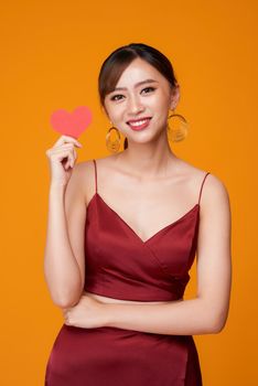Woman holding paper heart shaped card 