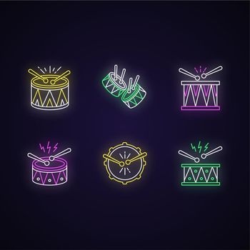 Brazilian music neon light icons set. Drums with drumsticks. Samba. Musical instrument. Brazilian carnival. Festive parade. Signs with outer glowing effect. Vector isolated RGB color illustrations