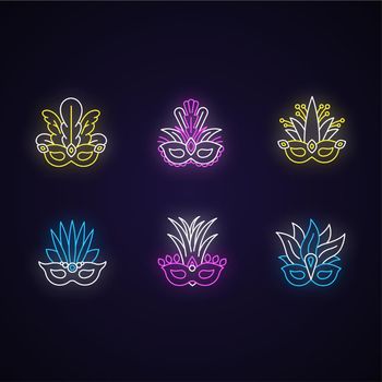 Masquerade masks neon light icons set. Traditional headwear with plumage. Ethnic festival. Brazilian national holiday. Signs with outer glowing effect. Vector isolated RGB color illustrations