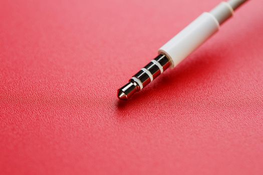 White connector auxiliary white cable on a red background