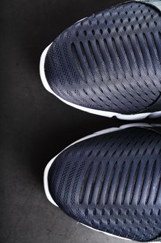 Black and white ultra-modern sports sneakers on a black background.