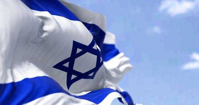 Detail of the national flag of Israel waving in the wind on a clear day