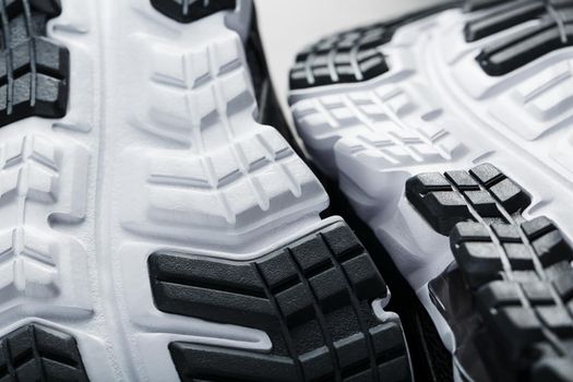 The sole of the sports sneakers for running in black and white close-up