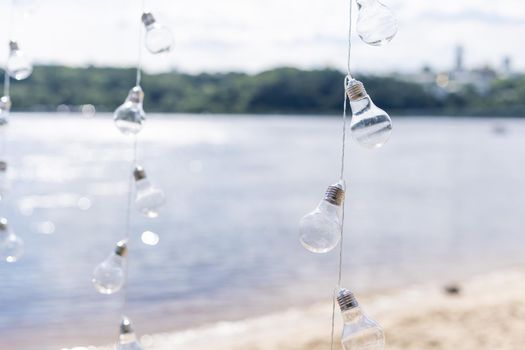 Hanging light bulbs on a background of water