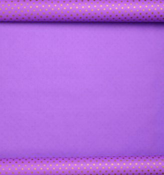Purple paper bundle in a golden dot deployed, wrapping paper