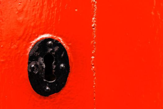 keyhole in an old door with an interesting texture, a remnant of an old entrance security