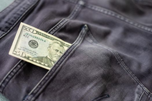 American dollar bills in jeans pocket background