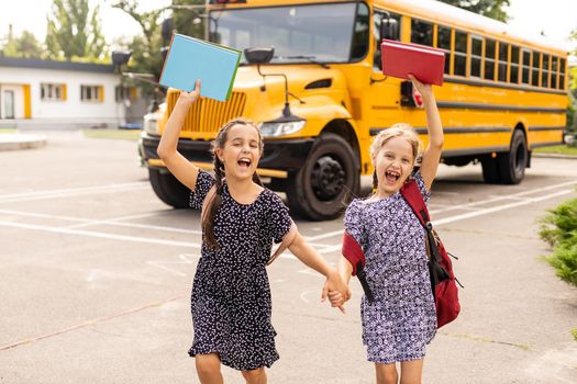 adorable schoolchildren running to school bus.