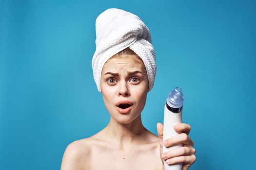 cheerful woman with a towel on her head removing blackheads skin care