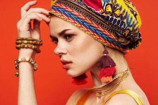 cheerful woman ethnicity multicolored headscarf makeup glamor red background