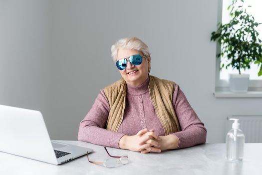 Progressive modern granny concept. Smiling elderly woman blogger.