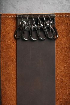 Wallet Keymaster made of brown Genuine leather, handmade on a dark background
