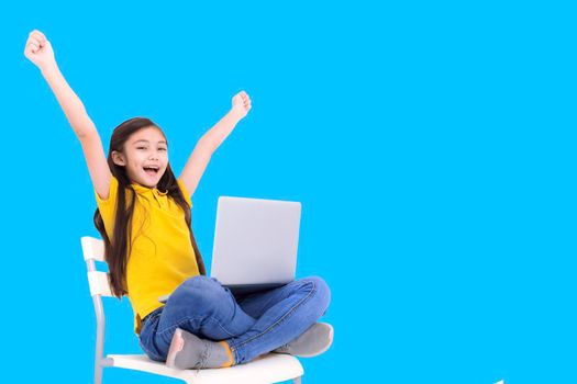 happy student girl holding laptop computer while sitting on the chair