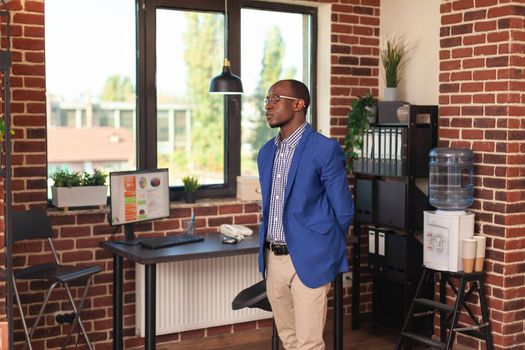 Business man standing in company office to think about strategy and innovation