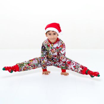 Boy in Christmas outfit doing a handstand and splits
