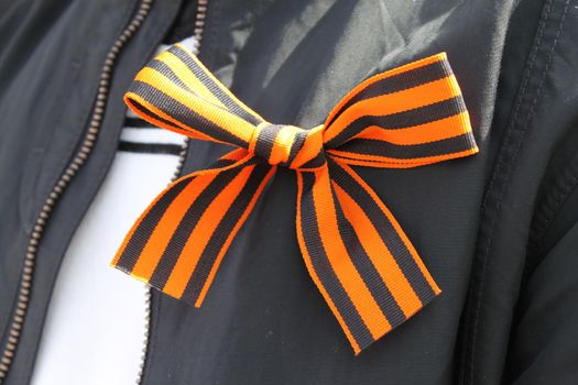 saint george striped ribbon on man clothes. 9 may victory day in russia