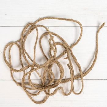 twine tangled on a white wooden surface