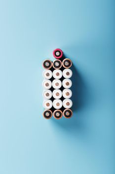 AA batteries are arranged in the form of a large battery on a blue background.