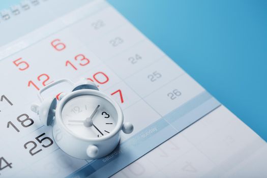 Annual calendar with a white alarm clock on a blue background