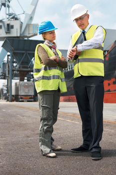 Time is of the essence.. Two engineers discussing planning on a site while in the shipyard.