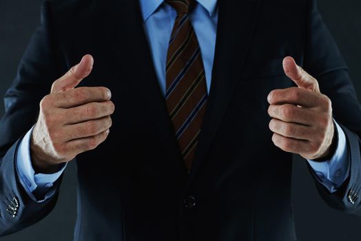 Let's embrace to seal the deal. Shot of an unrecognizable businessman gesturing with his hands.