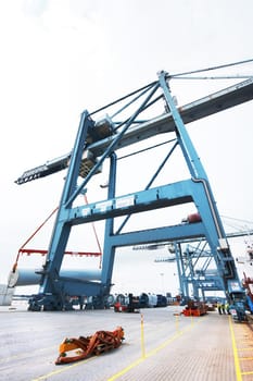 Great minds can create great machines. Cranes and vehicles on the dock at the shipyard.