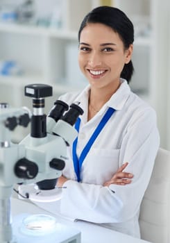 Medical research that makes a difference. Portrait of a young scientist using a microscope in a laboratory.
