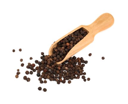 Wooden scoop full of black peppercorns