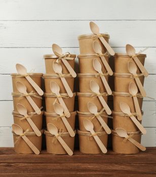 Stack of brown paper cups with dessert