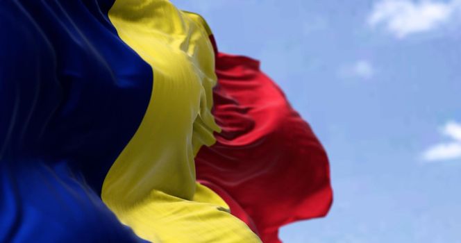 Detail of the national flag of Romania waving in the wind on a clear day