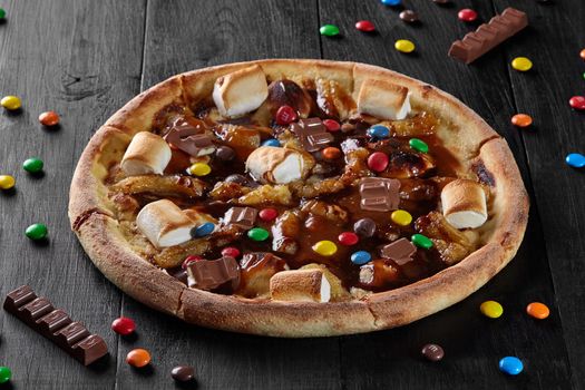 Sweet pizza with caramelized banana, marshmallow, chocolate dragee