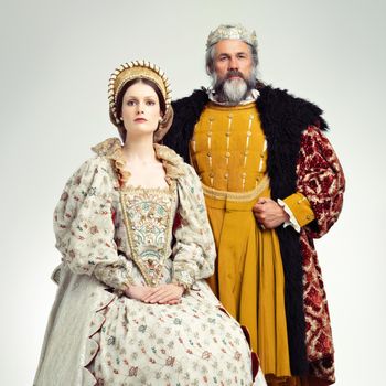 Stern and regal. Studio shot of a regal king and queen.