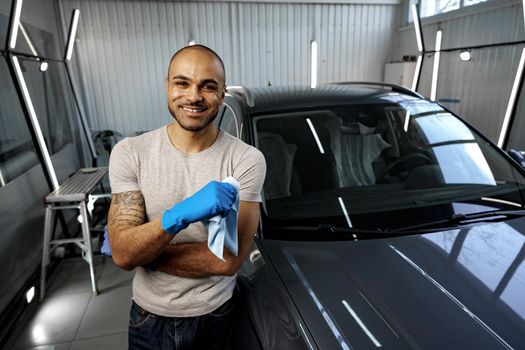 Portrait of African American man, car wash detailing service worker