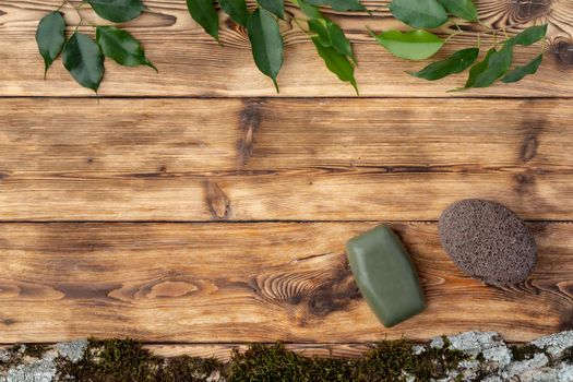 Spa photo with soap on rustic wooden background, top view